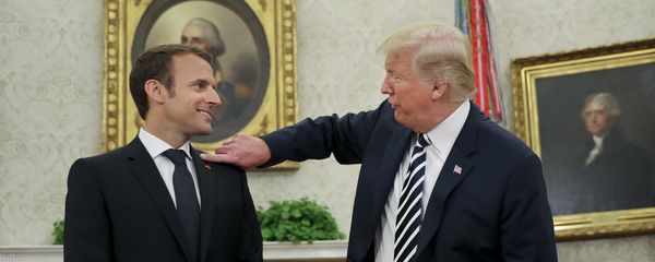 President Donald Trump playfully reaches over to cleans lint off French President Emmanuel Macron's suit jacket during their meeting in Oval Office of the White House in Washington, Tuesday, April 24, 2018 - Sputnik International