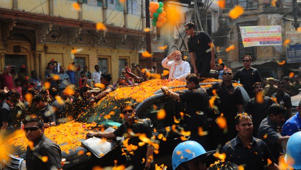 Indian Prime Minister Narendra Modi and leader of the Bharatiya Janata Party (BJP) gestures during a roadshow in support of state assembly election party candidates in Varanasi on March 4, 2017 - Sputnik International