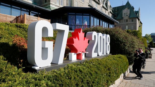 A photojournalist takes pictures of the G7 sign before the start of the G7 Summit in La Malbaie, Quebec, Canada, June 8, 2018. REUTERS/Yves Herman A photojournalist takes pictures of the G7 sign before the start of the G7 Summit in La Malbaie, Quebec, Canada, June 8, 2018. REUTERS/Yves Herman - Sputnik International