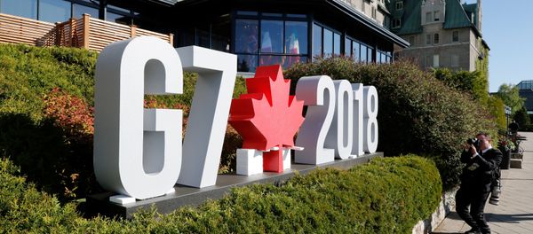 A photojournalist takes pictures of the G7 sign before the start of the G7 Summit in La Malbaie, Quebec, Canada, June 8, 2018. REUTERS/Yves Herman A photojournalist takes pictures of the G7 sign before the start of the G7 Summit in La Malbaie, Quebec, Canada, June 8, 2018. REUTERS/Yves Herman - Sputnik International