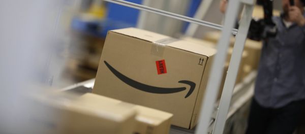 Boxes move down a conveyor belt at an Amazon fulfillment center Boxes move down a conveyor belt at an Amazon fulfillment center - Sputnik International