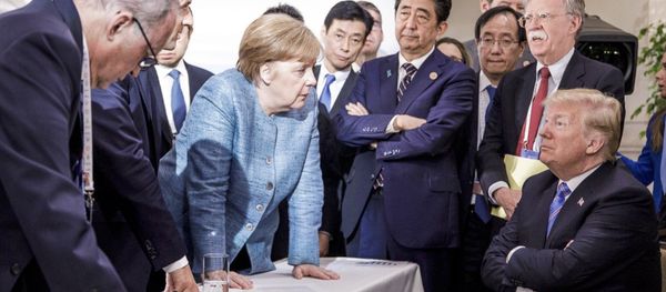 German Chancellor Angela Merkel, center, details policy to US President Donald Trump, seated at right, during the G7 Leaders Summit in La Malbaie, Quebec, Canada, on Saturday, June 9, 2018 German Chancellor Angela Merkel, center, details policy to US President Donald Trump, seated at right, during the G7 Leaders Summit in La Malbaie, Quebec, Canada, on Saturday, June 9, 2018 - Sputnik International