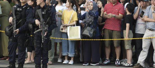 Police officers stand guard as they wait for North Korean leader Kim Jong Un's motorcade at the Istana, or Presidential Palace, in Singapore on Sunday, June 10, 2018, He met with Singapore Prime Minister Lee Hsien Loong ahead of his summit with U.S. leader Donald Trump - Sputnik International