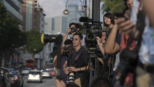 Journalists wait for North Korean leader Kim Jong Un outside the Istana, or Presidential Palace, in Singapore, Sunday, June 10, 2018, Kim met with Singapore Prime Minister Lee Hsien Loong ahead of the summit with U.S. leader Donald Trump - Sputnik International
