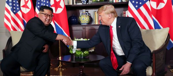 U.S. President Donald Trump shakes hands with North Korea's leader Kim Jong Un before their bilateral meeting at the Capella Hotel on Sentosa island in Singapore June 12, 2018. - Sputnik International