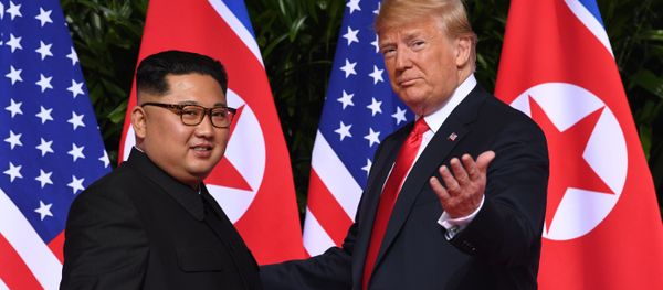 US President Donald Trump (R) gestures as he meets with North Korea's leader Kim Jong Un (L) at the start of their historic US-North Korea summit, at the Capella Hotel on Sentosa island in Singapore on June 12, 2018. - Sputnik International