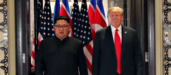 U.S. President Donald Trump and North Korea's leader Kim Jong Un arrive to sign documents that acknowledge the progress of the talks and pledge to keep momentum going, after their summit at the Capella Hotel on Sentosa island in Singapore June 12, 2018 - Sputnik International