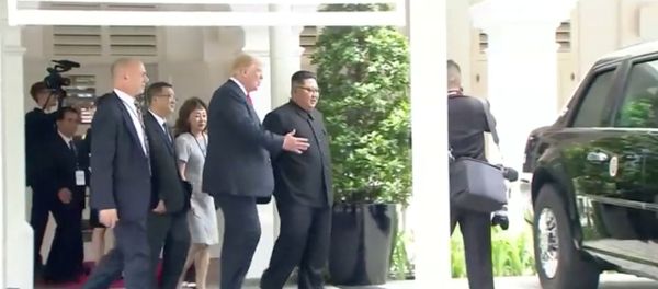 U.S. President Donald Trump shows North Korean leader Kim Jong Un his car, nicknamed The Beast, during their walk around Capella hotel after a working lunch at a summit in Singapore, June 12, 2018, in this still image taken from video U.S. President Donald Trump shows North Korean leader Kim Jong Un his car, nicknamed The Beast, during their walk around Capella hotel after a working lunch at a summit in Singapore, June 12, 2018, in this still image taken from video - Sputnik International