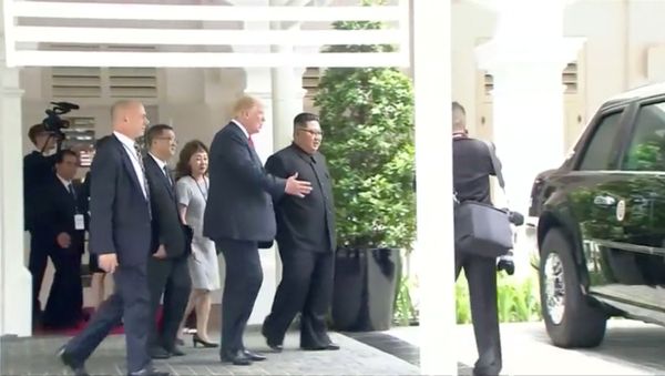 U.S. President Donald Trump shows North Korean leader Kim Jong Un his car, nicknamed The Beast, during their walk around Capella hotel after a working lunch at a summit in Singapore, June 12, 2018, in this still image taken from video - Sputnik International