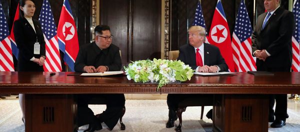 U.S. President Donald Trump and North Korea's leader Kim Jong Un look at each others before signing documents that acknowledge the progress of the talks and pledge to keep momentum going, after their summit at the Capella Hotel on Sentosa island in Singapore June 12, 2018 U.S. President Donald Trump and North Korea's leader Kim Jong Un look at each others before signing documents that acknowledge the progress of the talks and pledge to keep momentum going, after their summit at the Capella Hotel on Sentosa island in Singapore June 12, 2018 - Sputnik International