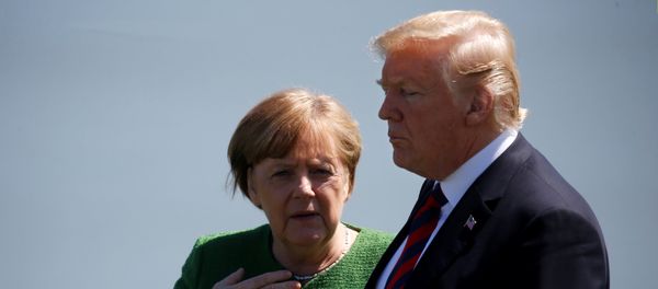 Germany's Chancellor Angela Merkel talks with U.S. President Donald Trump during a family photo at the G7 Summit in Charlevoix, Quebec, Canada, June 8, 2018 Germany's Chancellor Angela Merkel talks with U.S. President Donald Trump during a family photo at the G7 Summit in Charlevoix, Quebec, Canada, June 8, 2018 - Sputnik International