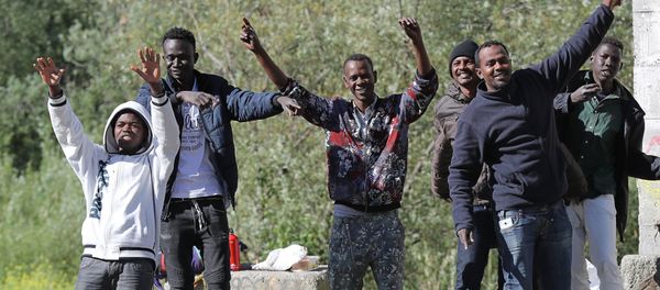 Migrants dance and cheer as they assist at the start of the citizens and solidarity march, in Ventimiglia, an Italian city near the border between Italy and France, on April 30, 2018. Some 60 people, gathered on April 30, 2018 in Ventimiglia at the French and Italian border Migrants dance and cheer as they assist at the start of the citizens and solidarity march, in Ventimiglia, an Italian city near the border between Italy and France, on April 30, 2018. Some 60 people, gathered on April 30, 2018 in Ventimiglia at the French and Italian border - Sputnik International