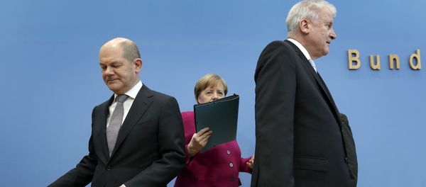 In this March 12, 2018 photo, from left, Olaf Scholz, acting chairman of the German Social Democratic Party (SPD), German Chancellor and chairwoman of the German Christian Democratic Union (CDU), Angela Merkel, and the chairman of the German Christian Social Union (CSU), Horst Seehofer, arrive for a joint press conference in Berlin, Germany - Sputnik International