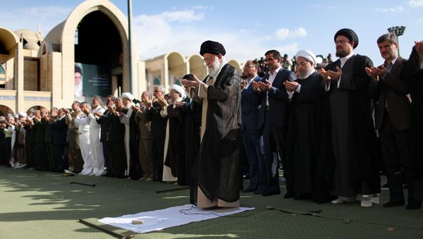 A handout picture released by the official website of the Iranian supreme leader shows Ayatollah Ali Khamenei (L) leading the Eid al-Fitr prayers at the Imam Khomeini grand mosque in the capital Tehran on June 15, 2018 A handout picture released by the official website of the Iranian supreme leader shows Ayatollah Ali Khamenei (L) leading the Eid al-Fitr prayers at the Imam Khomeini grand mosque in the capital Tehran on June 15, 2018 - Sputnik International