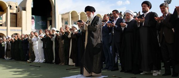 A handout picture released by the official website of the Iranian supreme leader shows Ayatollah Ali Khamenei (L) leading the Eid al-Fitr prayers at the Imam Khomeini grand mosque in the capital Tehran on June 15, 2018 A handout picture released by the official website of the Iranian supreme leader shows Ayatollah Ali Khamenei (L) leading the Eid al-Fitr prayers at the Imam Khomeini grand mosque in the capital Tehran on June 15, 2018 - Sputnik International