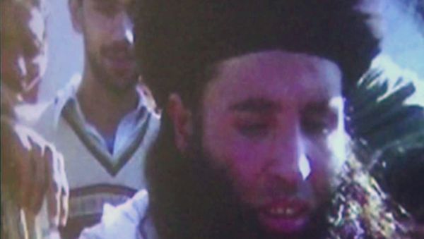 In this image made from video broadcast in 2013, undated footage of Mullah Fazlullah is shown on a projector in Pakistan. Fazlullah was the emir of the Tehrik-e-Taliban Pakistan (TTP) before he was reportedly killed in a drone strike on June 15, 2018. - Sputnik International