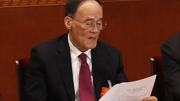 Chinese Vice President Wang Qishan reads a document during the closing session of the annual National People's Congress in the Great Hall of the People in Beijing, China, Tuesday, March 20, 2018 - Sputnik International