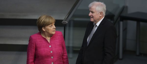 German Chancellor Angela Merkel, left, talks with German Interior Minister Horst Seehofer, right, during the first day of the budget 2018 debate at the parliament Bundestag at the Reichstag building in Berlin, Tuesday, May 15, 2018 - Sputnik International