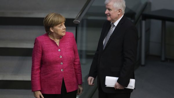 German Chancellor Angela Merkel, left, talks with German Interior Minister Horst Seehofer, right, during the first day of the budget 2018 debate at the parliament Bundestag at the Reichstag building in Berlin, Tuesday, May 15, 2018 German Chancellor Angela Merkel, left, talks with German Interior Minister Horst Seehofer, right, during the first day of the budget 2018 debate at the parliament Bundestag at the Reichstag building in Berlin, Tuesday, May 15, 2018 - Sputnik International