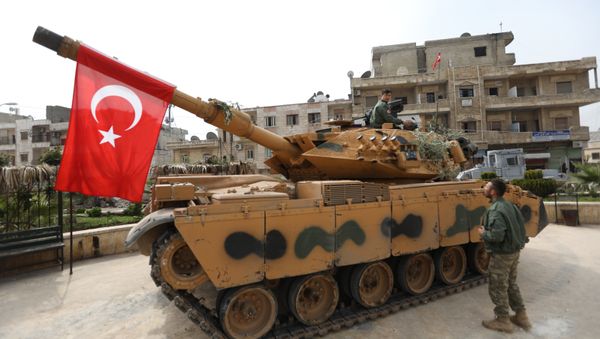 A tank belonging to Turkish soldiers and Ankara-backed Syrian Arab fighters is seen in the Kurdish-majority city of Afrin in northwestern Syria after they took control of it from Kurdish People's Protection Units (YPG) on March 18, 2018 A tank belonging to Turkish soldiers and Ankara-backed Syrian Arab fighters is seen in the Kurdish-majority city of Afrin in northwestern Syria after they took control of it from Kurdish People's Protection Units (YPG) on March 18, 2018 - Sputnik International