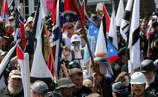In this Saturday, Aug. 12, 2017, file photo, white nationalist demonstrators walk into the entrance of Lee Park surrounded by counter demonstrators in Charlottesville, Va.  - Sputnik International