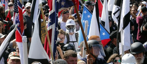 In this Saturday, Aug. 12, 2017, file photo, white nationalist demonstrators walk into the entrance of Lee Park surrounded by counter demonstrators in Charlottesville, Va. In this Saturday, Aug. 12, 2017, file photo, white nationalist demonstrators walk into the entrance of Lee Park surrounded by counter demonstrators in Charlottesville, Va. - Sputnik International