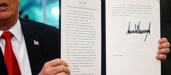 U.S. President Donald Trump displays an executive order on immigration policy after signing it in the Oval Office at the White House in Washington, U.S., June 20, 2018. U.S. President Donald Trump displays an executive order on immigration policy after signing it in the Oval Office at the White House in Washington, U.S., June 20, 2018. - Sputnik International