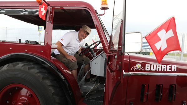 Swiss fan Beat Studer looks at an old-time tractor after driving with two friends, from home to Kaliningrad stadium to watch their team playing against Serbia, in Kaliningrad, Russia June 21, 2018. - Sputnik International