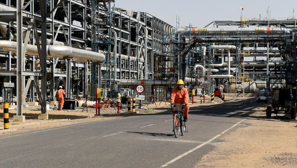 In this photograph taken on December 11, 2015, a worker cycles by machinery at Cairn India, Oil and Gas exploration plant at Barmer in Rajasthan In this photograph taken on December 11, 2015, a worker cycles by machinery at Cairn India, Oil and Gas exploration plant at Barmer in Rajasthan - Sputnik International