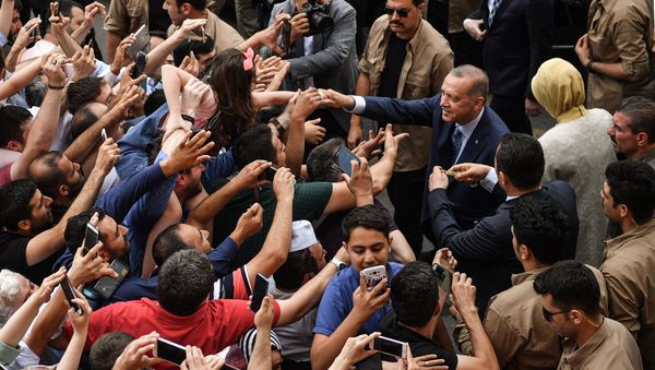 Turkey's President Recep Tayyip Erdogan, leader of the Justice and Development Party (AKP) and his wife Emine are greeted by supporters as they leave the polling station after casting their votes during snap twin Turkish presidential and parliamentary elections in Istanbul on June 24, 2018 Turkey's President Recep Tayyip Erdogan, leader of the Justice and Development Party (AKP) and his wife Emine are greeted by supporters as they leave the polling station after casting their votes during snap twin Turkish presidential and parliamentary elections in Istanbul on June 24, 2018 - Sputnik International