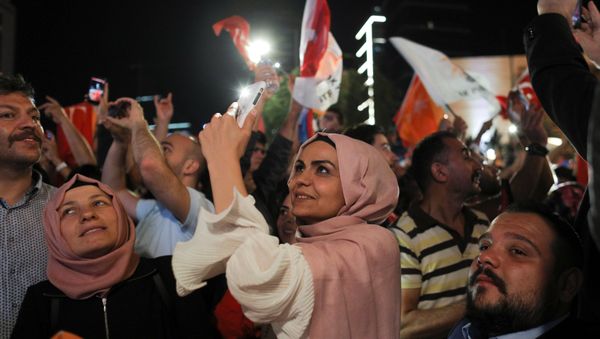 People take photographs as Turkish President Tayyip Erdogan (not pictured) addresses a speech at the AKP headquarters in Ankara, Turkey June 25, 2018 - Sputnik International