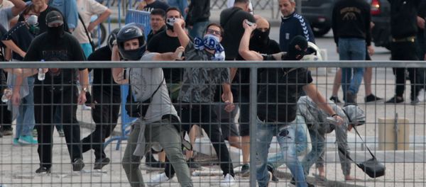Protesters throw stones during clashes with riot police in a protest against the agreement reached by Greece and Macedonia to resolve a dispute over the former Yugoslav republic's name, in Thessaloniki, Greece, June 25, 2018 - Sputnik International