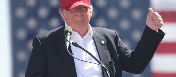 US President Donald Trump, then candidate Donald Trump, wears a Make America Great Again hat  at a rally in Arizona. - Sputnik International