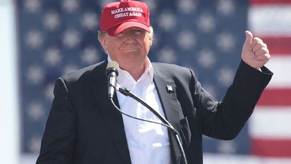 US President Donald Trump, then candidate Donald Trump, wears a Make America Great Again hat  at a rally in Arizona. - Sputnik International