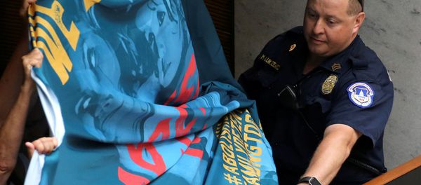 A U.S. Capitol Police officer attempts to take a protest banner from demonstrators calling for an end to family detention and in opposition to the immigration policies of the Trump administration, at the Hart Senate Office Building on Capitol Hill in Washington, U.S. June 28, 2018 A U.S. Capitol Police officer attempts to take a protest banner from demonstrators calling for an end to family detention and in opposition to the immigration policies of the Trump administration, at the Hart Senate Office Building on Capitol Hill in Washington, U.S. June 28, 2018 - Sputnik International