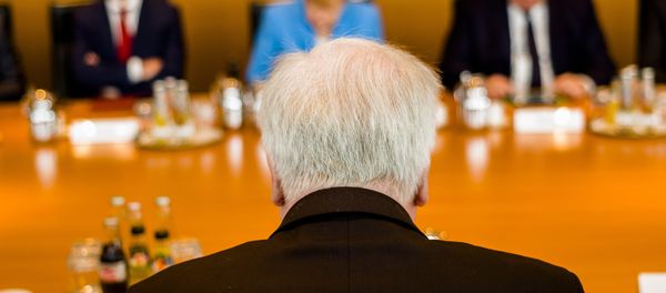 German Interior Minister Horst Seehofer, front, sits on the opposite of German German Chancellor Angela Merkel, center back ground, prior to the weekly cabinet meeting of the German government at the chancellery in Berlin, Wednesday, June 13, 2018. German Interior Minister Horst Seehofer, front, sits on the opposite of German German Chancellor Angela Merkel, center back ground, prior to the weekly cabinet meeting of the German government at the chancellery in Berlin, Wednesday, June 13, 2018. - Sputnik International