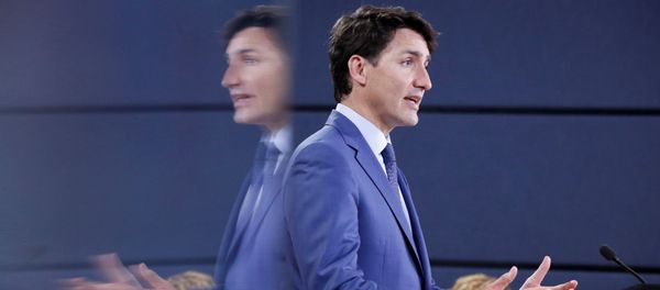 Canada's Prime Minister Justin Trudeau is reflected in a monitor while speaking during a news conference in Ottawa, Ontario, Canada, June 20, 2018 - Sputnik International