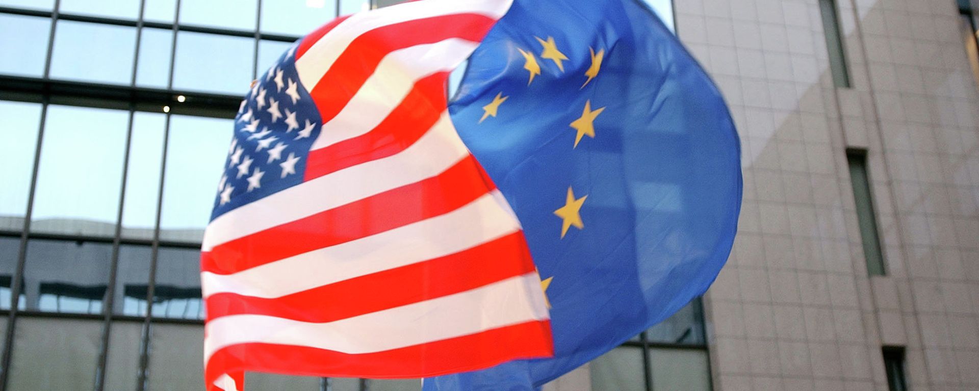 The US and EU flags, left and right, fly side by side at the European Council building in Brussels The US and EU flags, left and right, fly side by side at the European Council building in Brussels - Sputnik International, 1920, 11.11.2022