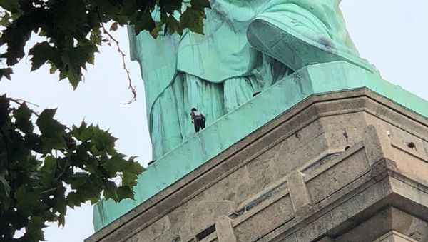 A protester is seen on the Statue of Liberty in New York, New York, U.S., July 4, 2018 in this picture obtained from social media A protester is seen on the Statue of Liberty in New York, New York, U.S., July 4, 2018 in this picture obtained from social media - Sputnik International