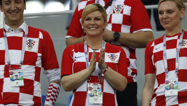 President Kolinda Grabar-Kitarovic, center, applauds prior the round of 16 match between Croatia and Denmark at the 2018 soccer World Cup in the Nizhny Novgorod Stadium, in Nizhny Novgorod , Russia, Sunday, July 1, 2018 - Sputnik International