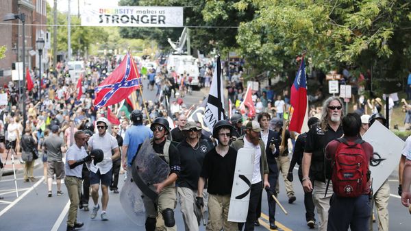 White nationalist demonstrators walk through town after their rally was declared illegal near Lee Park in Charlottesville, Va. White nationalist demonstrators walk through town after their rally was declared illegal near Lee Park in Charlottesville, Va. - Sputnik International