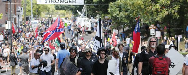White nationalist demonstrators walk through town after their rally was declared illegal near Lee Park in Charlottesville, Va. White nationalist demonstrators walk through town after their rally was declared illegal near Lee Park in Charlottesville, Va. - Sputnik International
