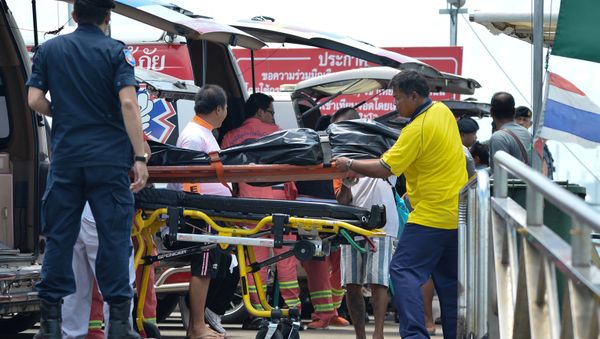 Thai Rescue workers carry the body of a victim on a stretcher, after a boat capsized off the tourist island of Phuket, Thailand, July 6, 2018 Thai Rescue workers carry the body of a victim on a stretcher, after a boat capsized off the tourist island of Phuket, Thailand, July 6, 2018 - Sputnik International