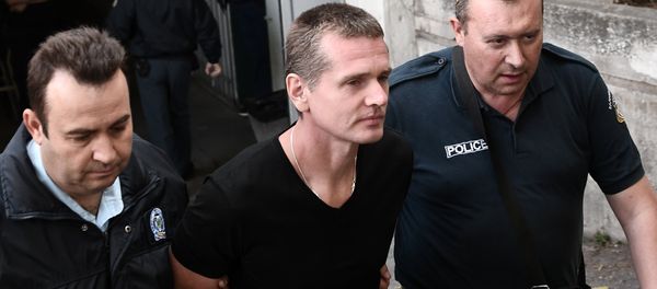 Russian Alexander Vinnik (C) is escorted by police officers as he arrives at a courthouse in Thessaloniki on October 4, 2017. Alexander Vinnik, who headed BTC-e, an exchange he operated for the Bitcoin crypto-currency, was indicted by a US court in late July on 21 charges ranging from identity theft and facilitating drug trafficking to money laundering Russian Alexander Vinnik (C) is escorted by police officers as he arrives at a courthouse in Thessaloniki on October 4, 2017. Alexander Vinnik, who headed BTC-e, an exchange he operated for the Bitcoin crypto-currency, was indicted by a US court in late July on 21 charges ranging from identity theft and facilitating drug trafficking to money laundering - Sputnik International