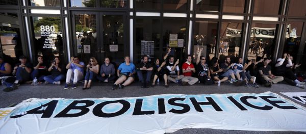 Protesters block the entrance to a downtown federal building housing Immigration and Customs Enforcement (ICE) offices Monday, July 2, 2018, in San Diego. - Sputnik International