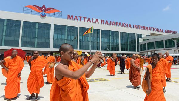 (File) A Sri Lankan Budhist monk takes pictures of an unseen Sri Lankan airlines Airbus A-340 which transported President Mahinda Rajapakse who became the first passenger to go through the facility, at the new Mattala Rajapaksa International Airport in Mattala, in the southeast of the island on March 18, 2013 - Sputnik International