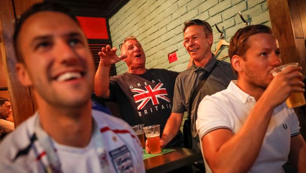Soccer Football - World Cup - Quarter-Final - Sweden vs England - Samara, Russia - July 6, 2018. Supporters of team England watch the broadcast of the match in a bar - Sputnik International
