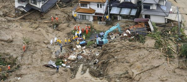 Rescue workers are seen next to houses damaged by a landslide following heavy rain in Hiroshima, western Japan, in this photo taken by Kyodo July 7, 2018 - Sputnik International