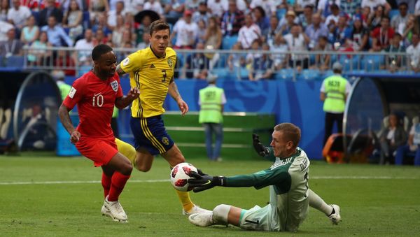 Sweden's goalkeeper Robin Olsen, right, makes a save against England's Raheem Sterling during the World Cup quarterfinal soccer match between Sweden and England at the Samara Arena, in Samara, Russia, July 7, 2018 - Sputnik International
