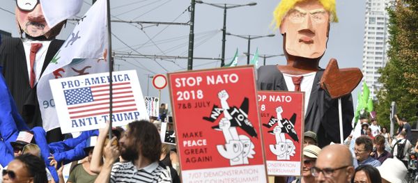 Protestors march next to giant puppets of U.S. President Donald Trump, right, and Belgian Prime Minister Charles Michel, left, during a demonstration in Brussels, Saturday, July 7, 2018 Protestors march next to giant puppets of U.S. President Donald Trump, right, and Belgian Prime Minister Charles Michel, left, during a demonstration in Brussels, Saturday, July 7, 2018 - Sputnik International